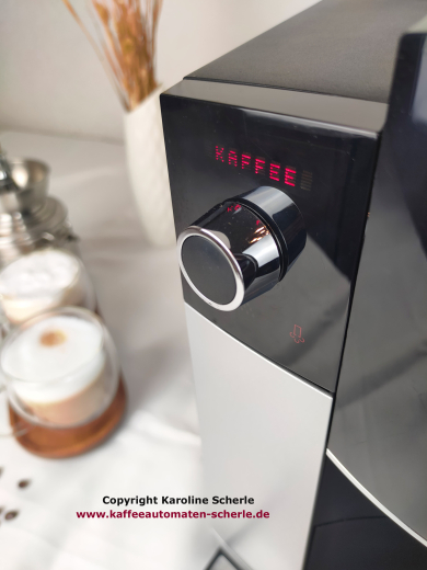 Nahaufnahme der JURA D6: rotes Klartextdisplay mit Anzeige Kaffee über dem Rotary Switch